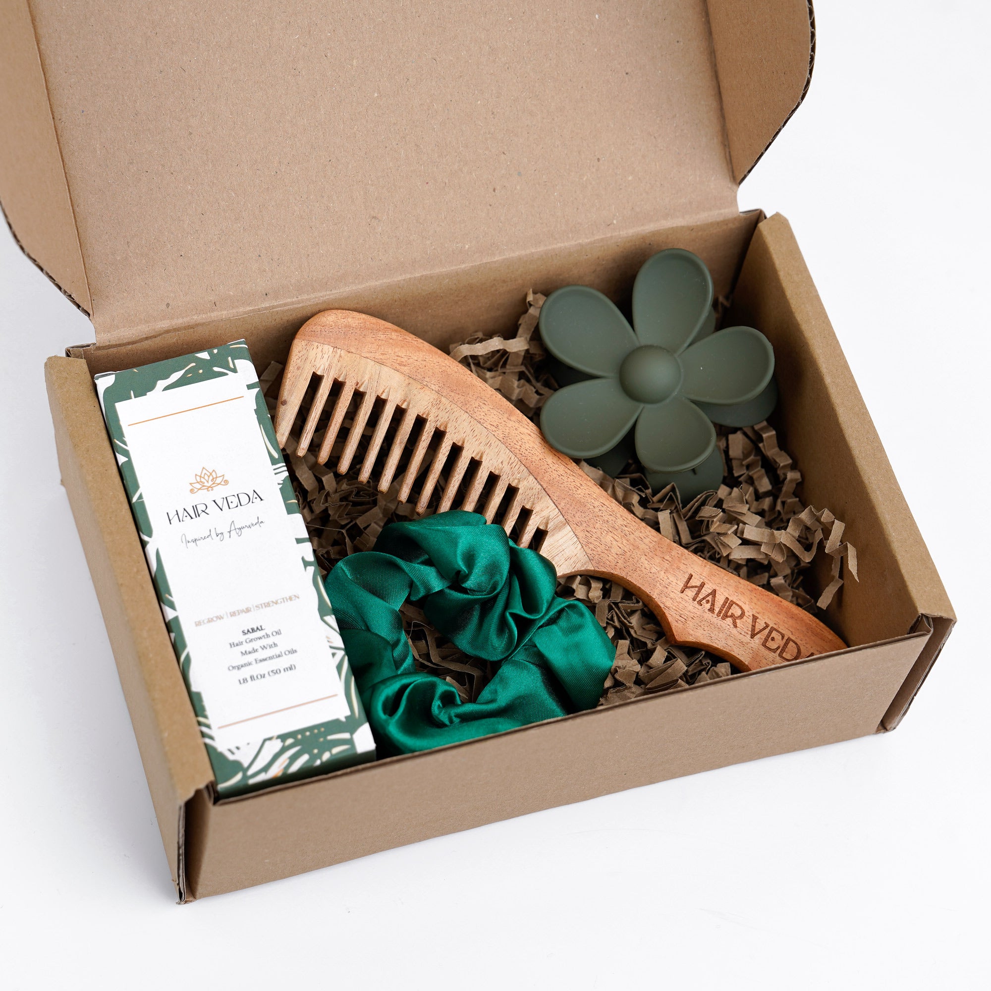 Happy Hair Kit box featuring a comb, hair brush, and a green hair tie inside.