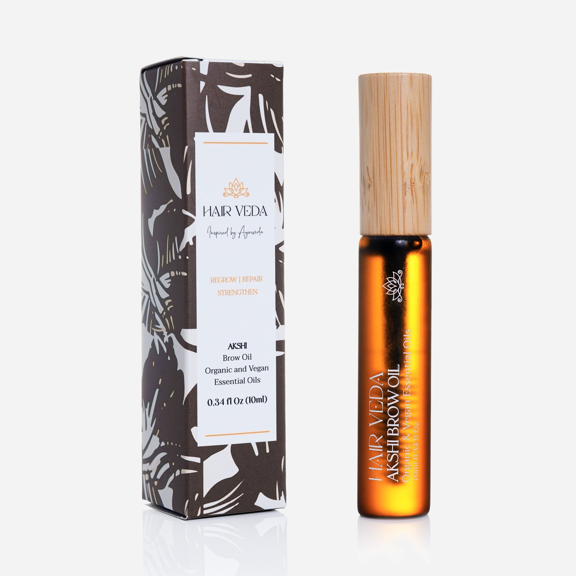 Akshi Brow oil in a bottle with a wooden stick for application.